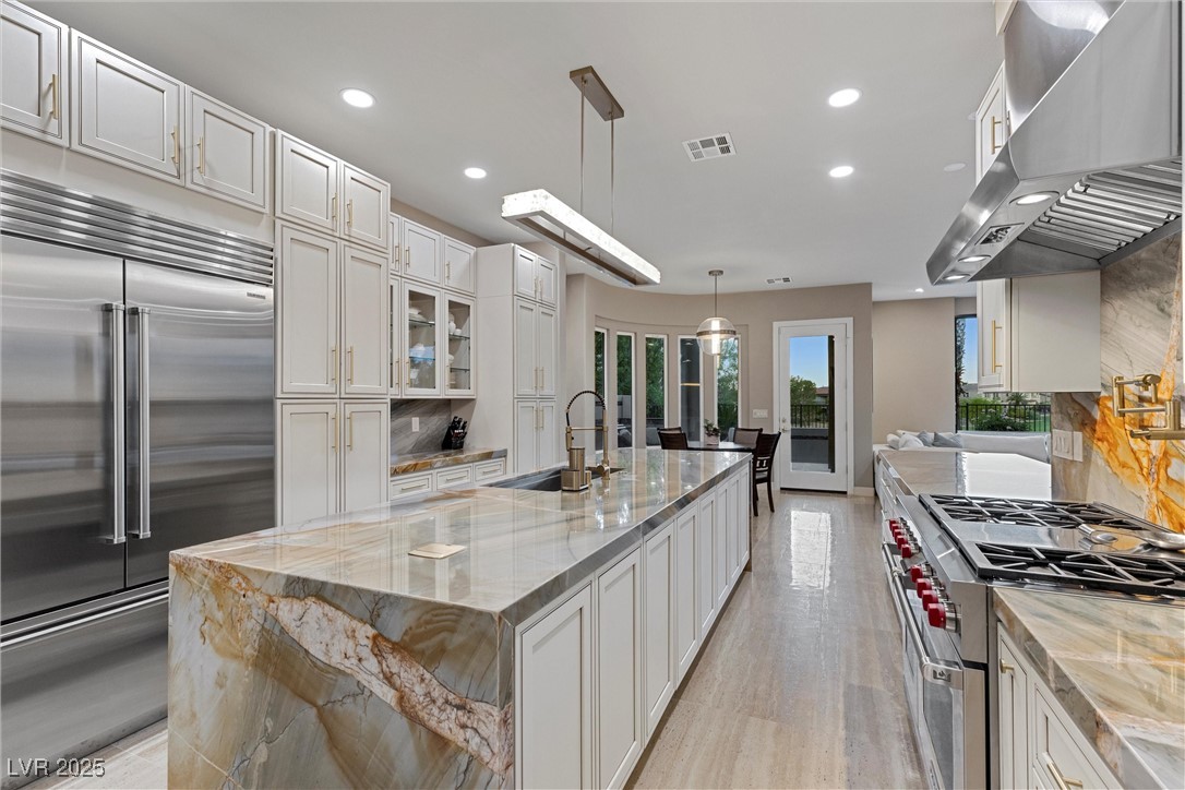 1911 Alcova Ridge Drive Las Vegas, NV 89135 - Photo 11 of 43 Kitchen with visible vents, recessed lighting, a sink, exhaust hood, and premium appliances