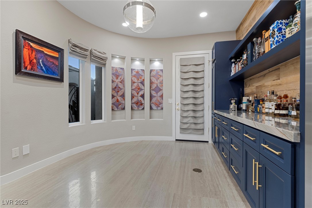 1911 Alcova Ridge Drive Las Vegas, NV 89135 - Photo 14 of 43 Bar with baseboards and light wood-style floors