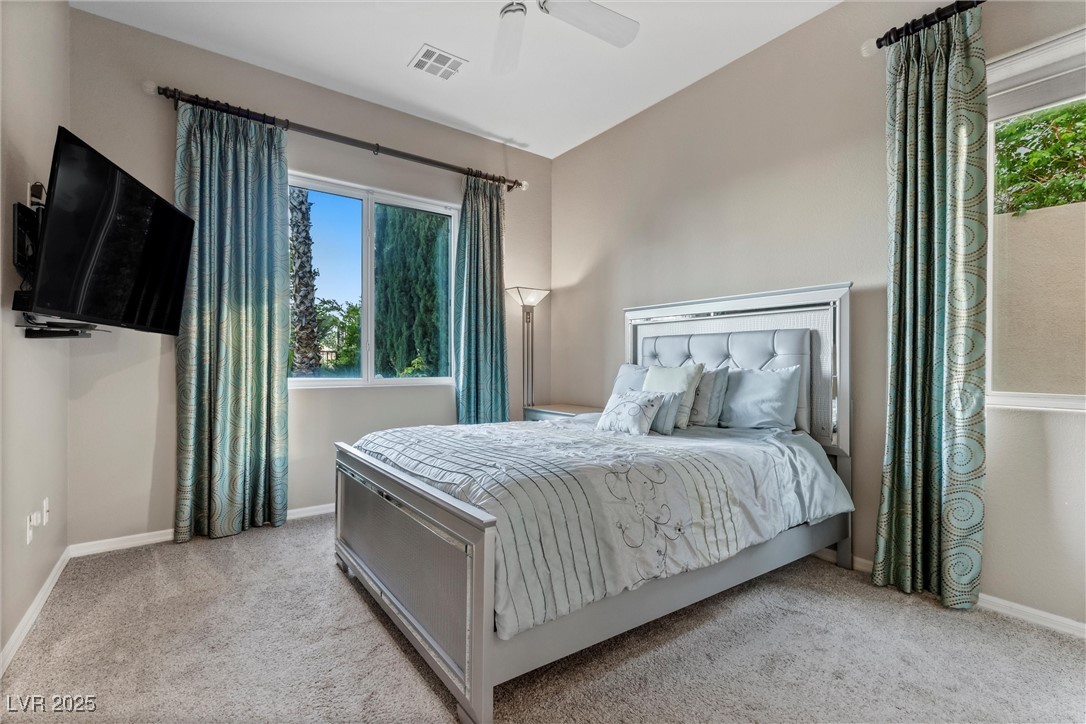 1911 Alcova Ridge Drive Las Vegas, NV 89135 - Photo 16 of 43 Bedroom with carpet floors, a ceiling fan, baseboards, and visible vents