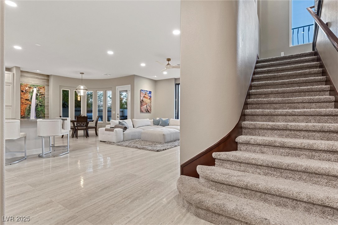 1911 Alcova Ridge Drive Las Vegas, NV 89135 - Photo 18 of 43 Staircase featuring a ceiling fan and recessed lighting