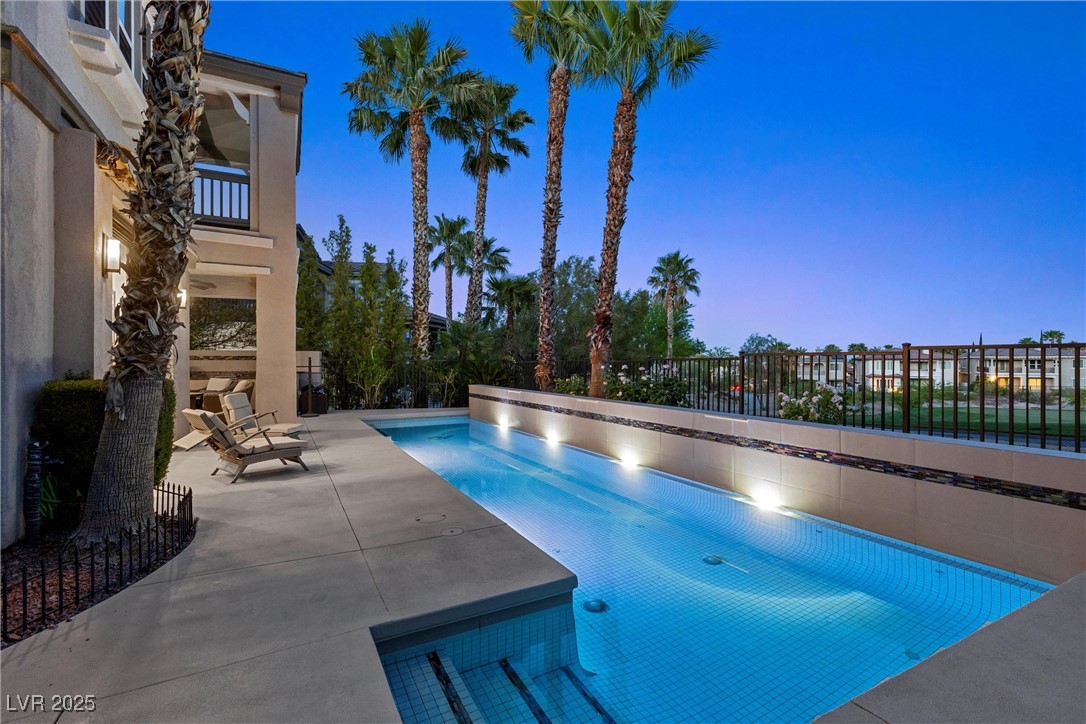 1911 Alcova Ridge Drive Las Vegas, NV 89135 - Photo 35 of 43 Pool at dusk featuring a fenced in pool, fence, and a patio