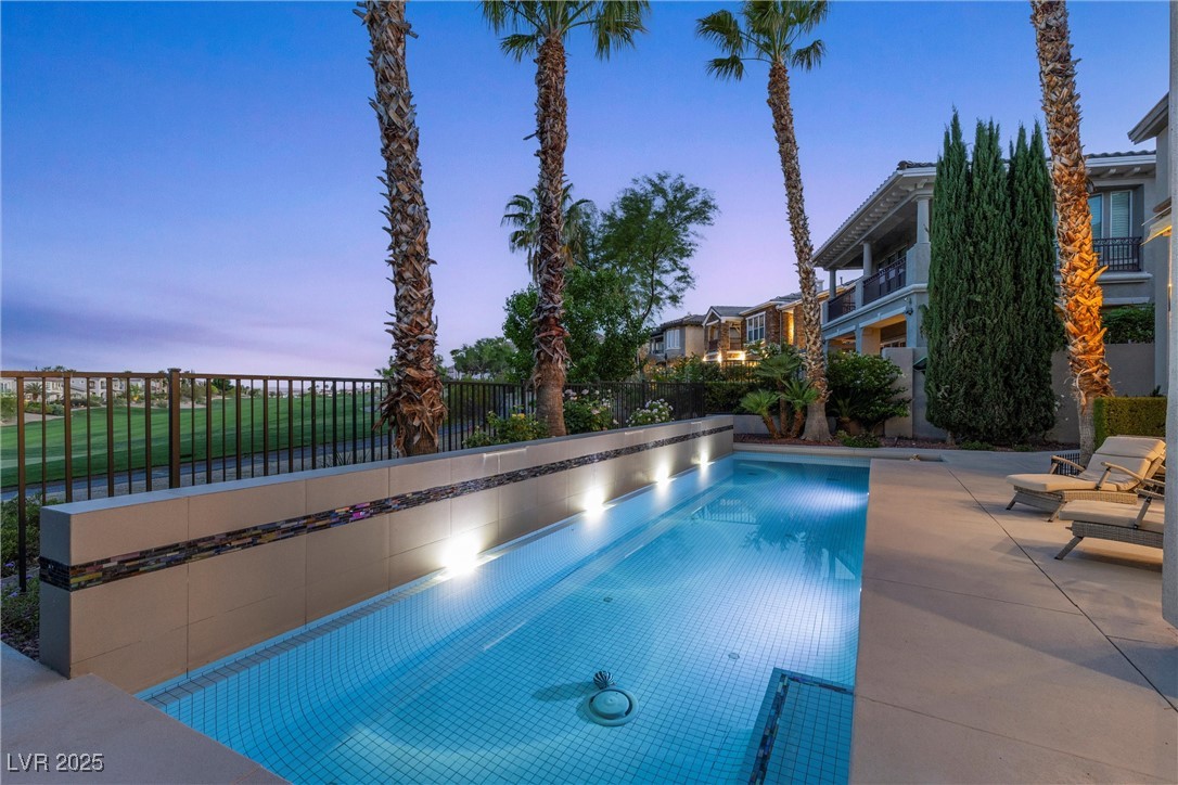 1911 Alcova Ridge Drive Las Vegas, NV 89135 - Photo 36 of 43 Pool at dusk with fence, a patio area, and a fenced in pool