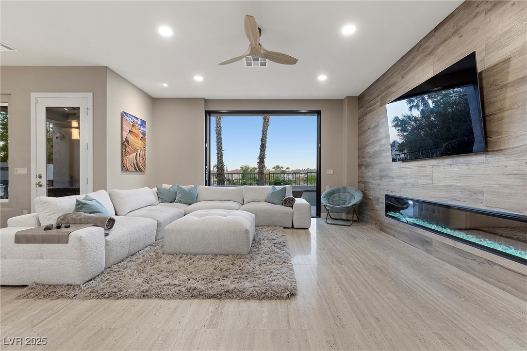 1911 Alcova Ridge Drive Las Vegas, NV 89135 - Photo 8 of 43 Living room featuring a fireplace, a ceiling fan, recessed lighting, and wood finished floors