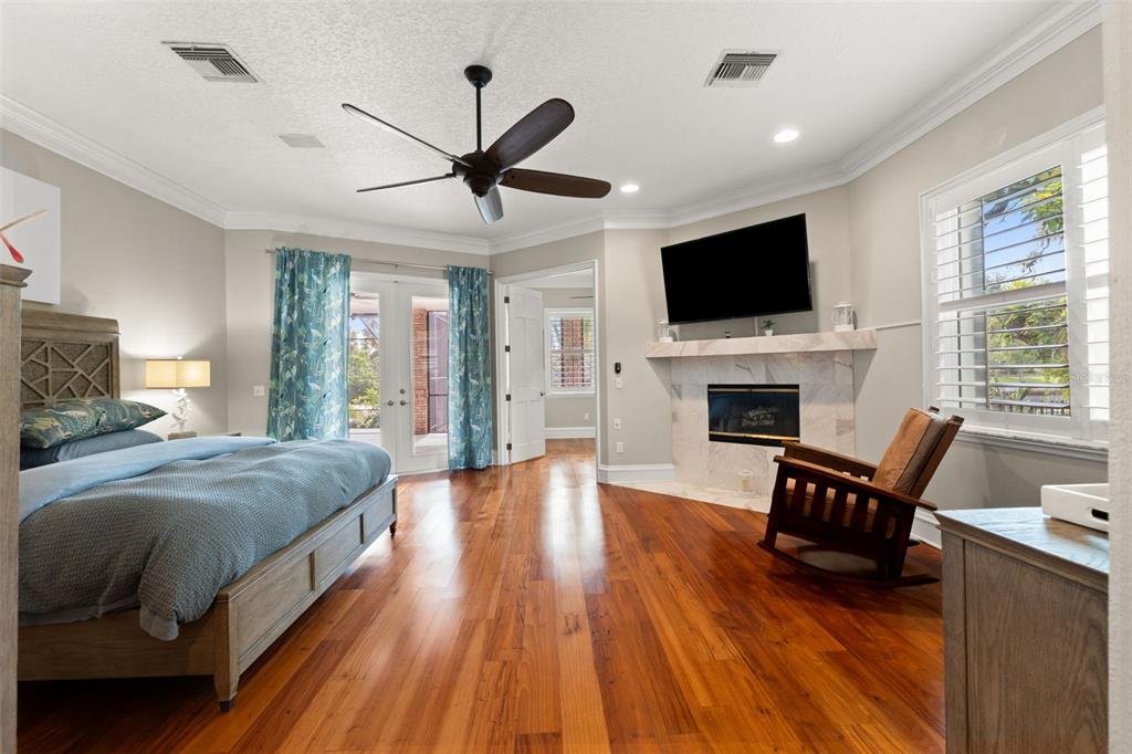 6936 River Road New Port Richey, FL 34652 - Photo 29 of 93 a spacious bedroom with a bed and a flat screen tv
