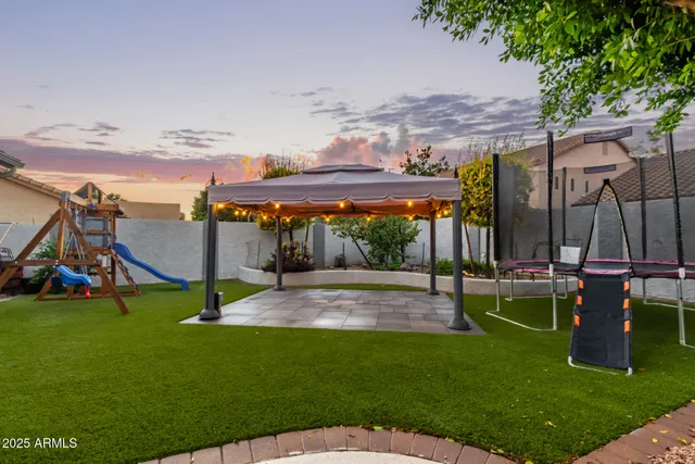 a view of a backyard with swimming pool
