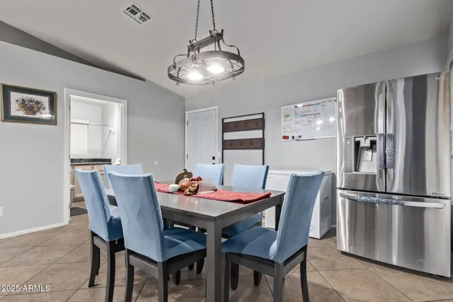 a dining room with furniture a chandelier and wooden floor