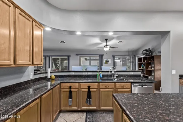 a kitchen with granite countertop a sink and a stove
