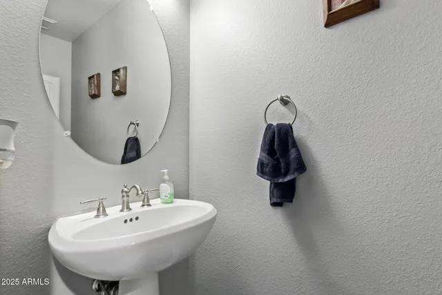 a bathroom with a sink and mirror