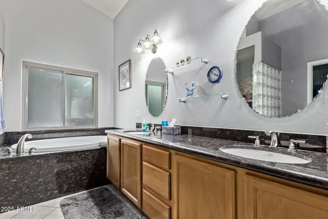 a bathroom with double vanity sinks and a mirror