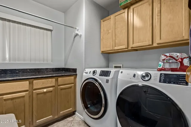 a view of a patio with a table and chairs under an umbrella