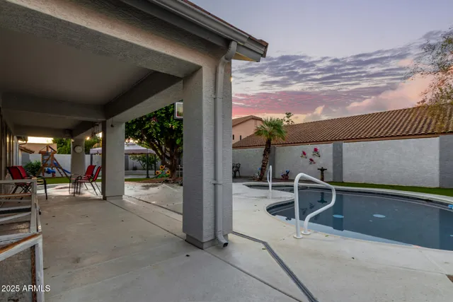 a view of a chairs and table in patio