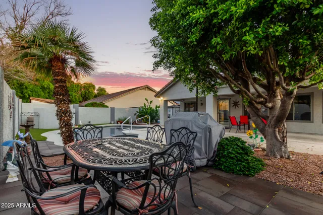 a view of a patio with table and chairs