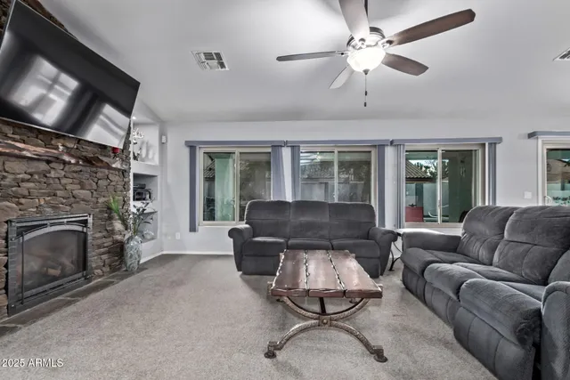 a dining room with furniture a chandelier and wooden floor