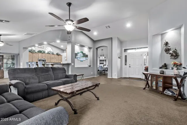 a kitchen with stainless steel appliances granite countertop a refrigerator a stove top oven a sink and dishwasher