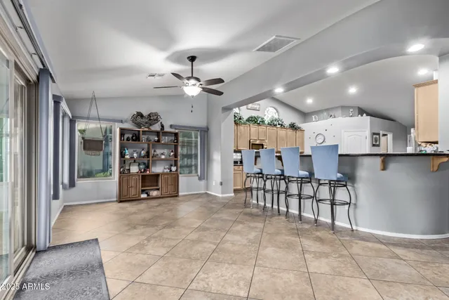 a kitchen with granite countertop a stove sink and refrigerator