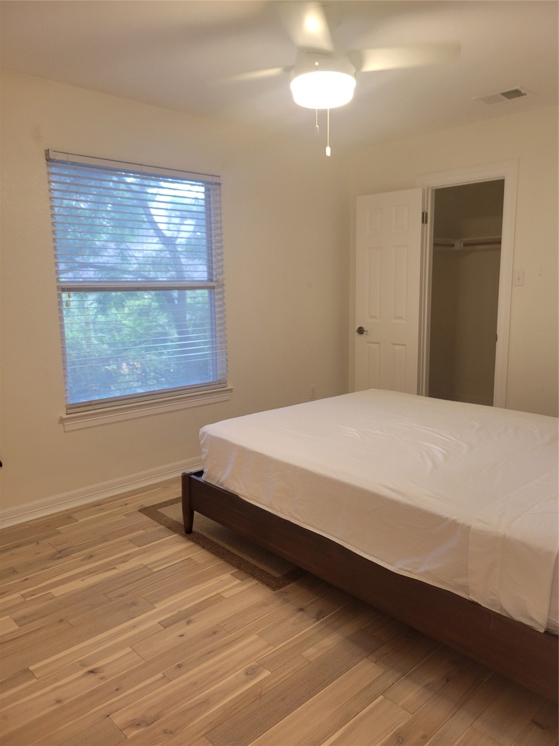 3203 Tom Green Street, Unit 3A Austin, TX 78705 - Photo 31 of 33 a spacious bedroom with a bed and a window