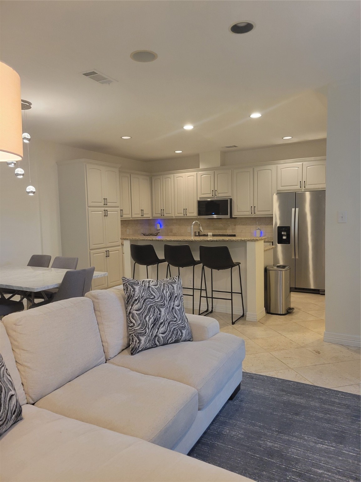 3203 Tom Green Street, Unit 3A Austin, TX 78705 - Photo 5 of 33 a living room kitchen with stainless steel appliances granite countertop a couch and a view of kitchen