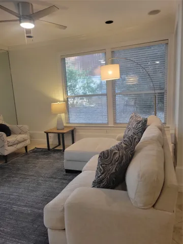 a bed sitting in a bedroom next to a lamp