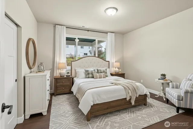 a bedroom with a bed a mirror and lamp