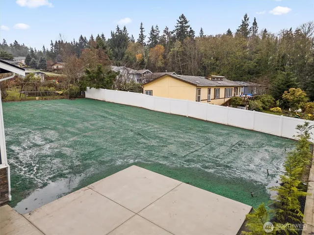a backyard of a house with table and chairs