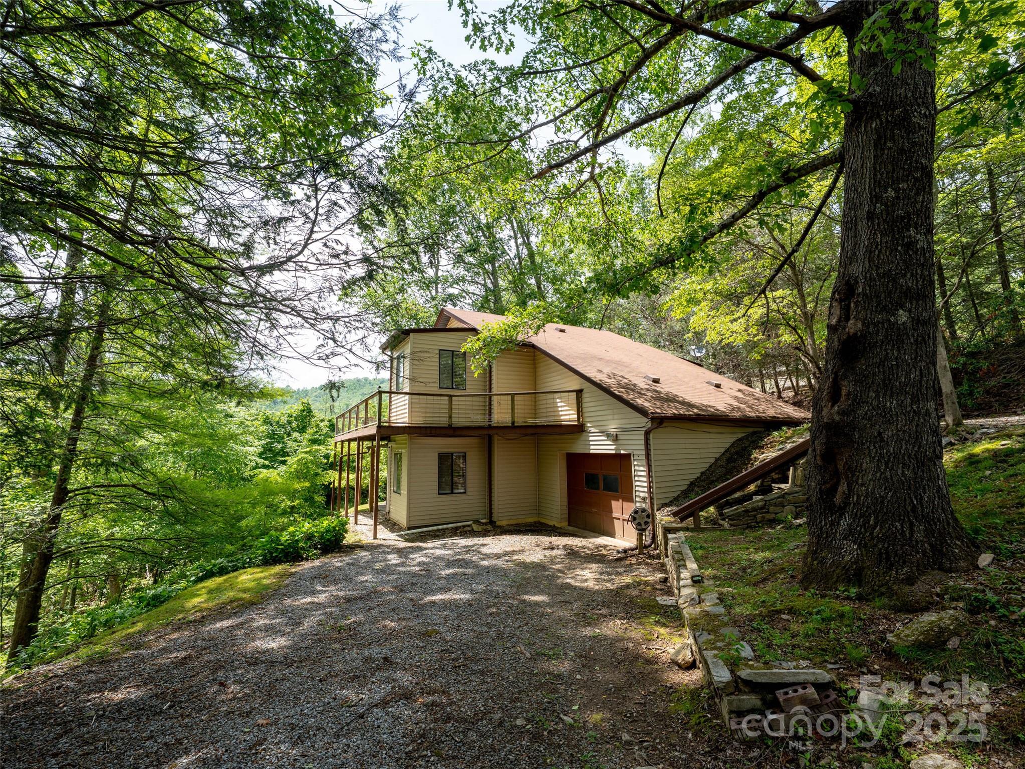 a yellow and red house with a tree in the background