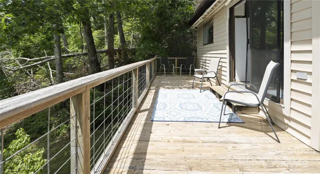 a view of balcony with wooden floor and seating