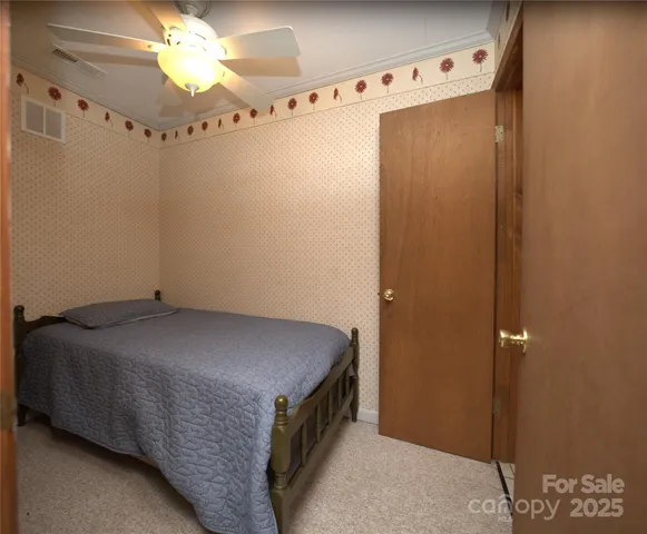 a en suite bathroom with a granite countertop sink and a mirror