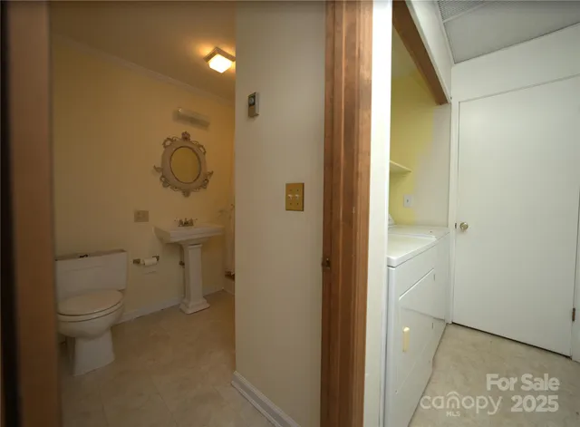 a bathroom with a granite countertop toilet and a shower