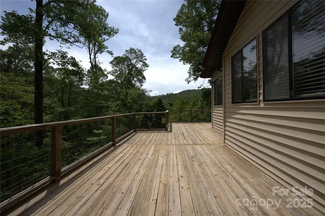 a view of balcony with wooden floor and fence