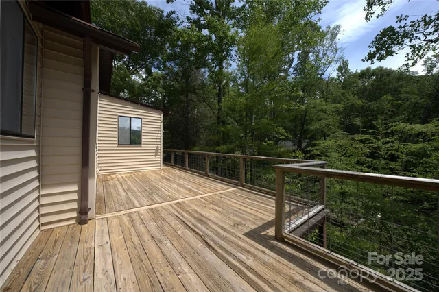 a view of balcony with wooden floor and fence