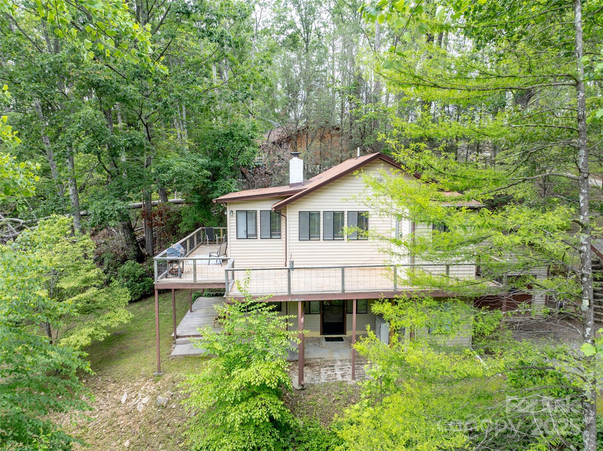 218 McGuffey Ridge Road Gerton, NC 28735 - Photo 6 of 29 a white house with tall trees