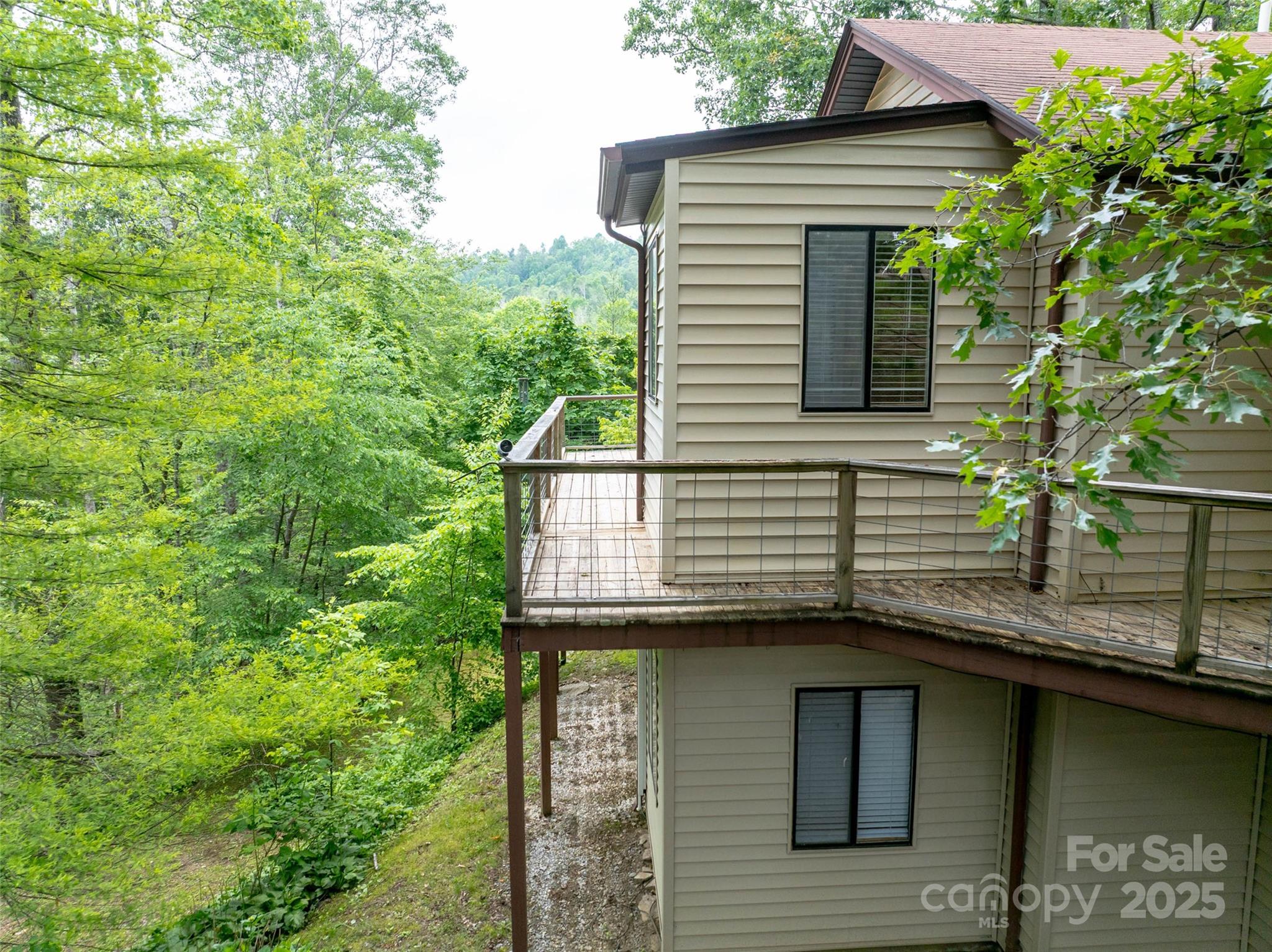 218 McGuffey Ridge Road Gerton, NC 28735 - Photo 8 of 29 a view of a house with a balcony