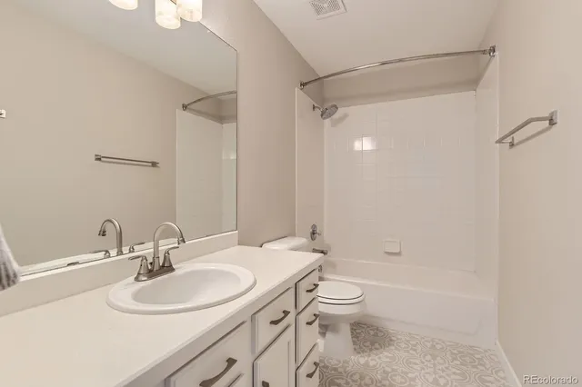 a bathroom with a sink toilet tub and shower