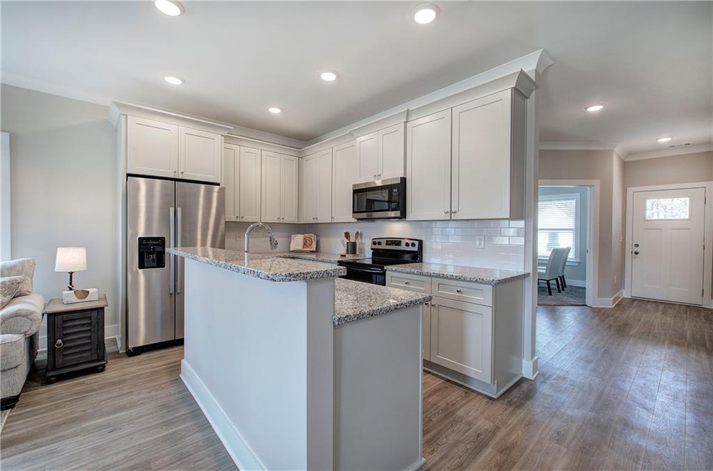 146 Sunflower Circle Cartersville, GA 30121 - Photo 11 of 44 a kitchen with cabinets and wooden floor