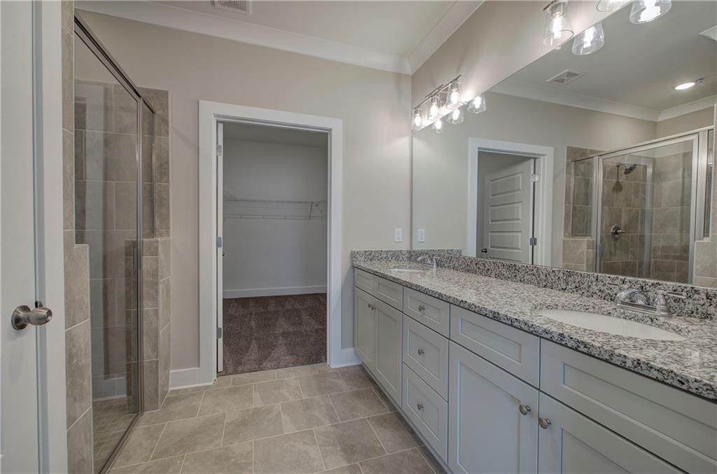 146 Sunflower Circle Cartersville, GA 30121 - Photo 21 of 44 a bathroom with a granite countertop sink a large mirror and a shower