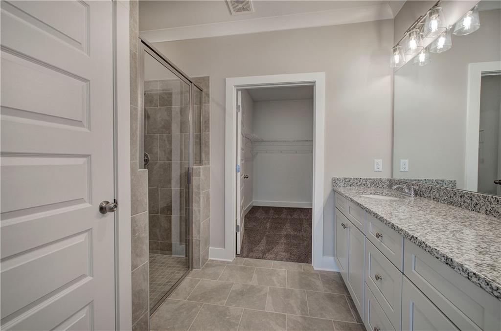 146 Sunflower Circle Cartersville, GA 30121 - Photo 22 of 44 a bathroom with a granite countertop sink a mirror and a shower