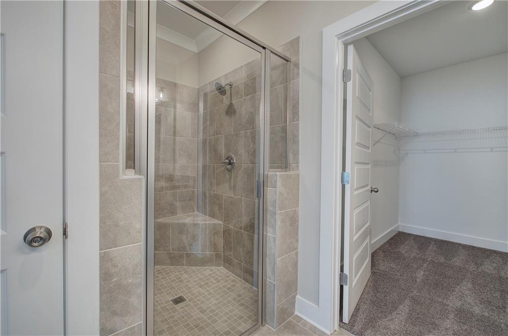 146 Sunflower Circle Cartersville, GA 30121 - Photo 23 of 44 a bathroom with a glass shower door