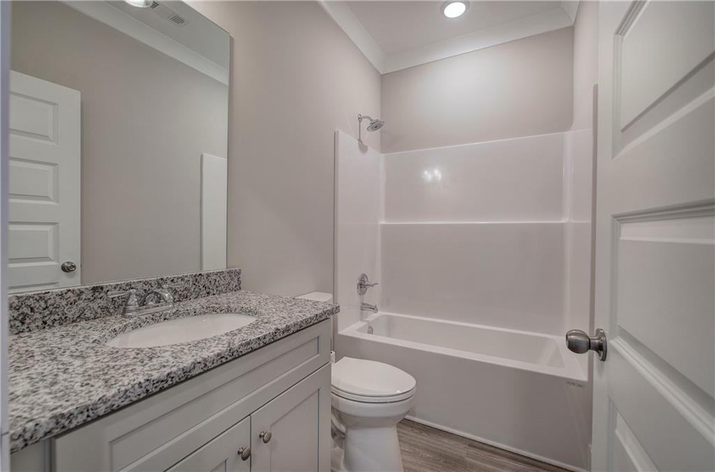 146 Sunflower Circle Cartersville, GA 30121 - Photo 32 of 44 a bathroom with a granite countertop sink toilet and shower