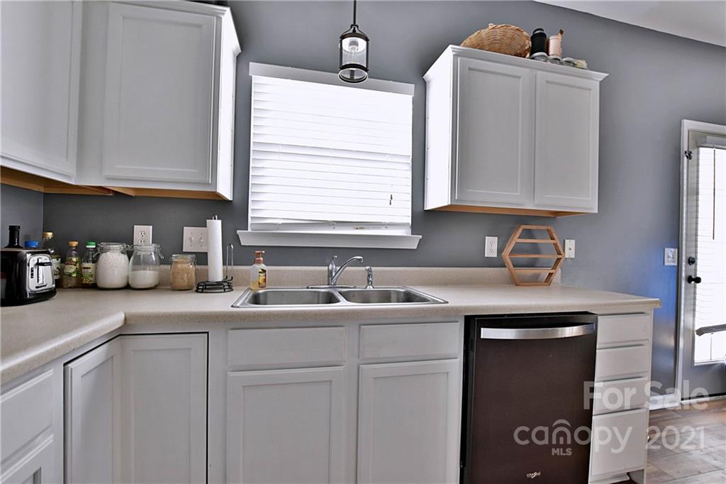 828 Dillard Road Rock Hill, SC 29730 - Photo 10 of 16 a kitchen with cabinets appliances a sink and a window