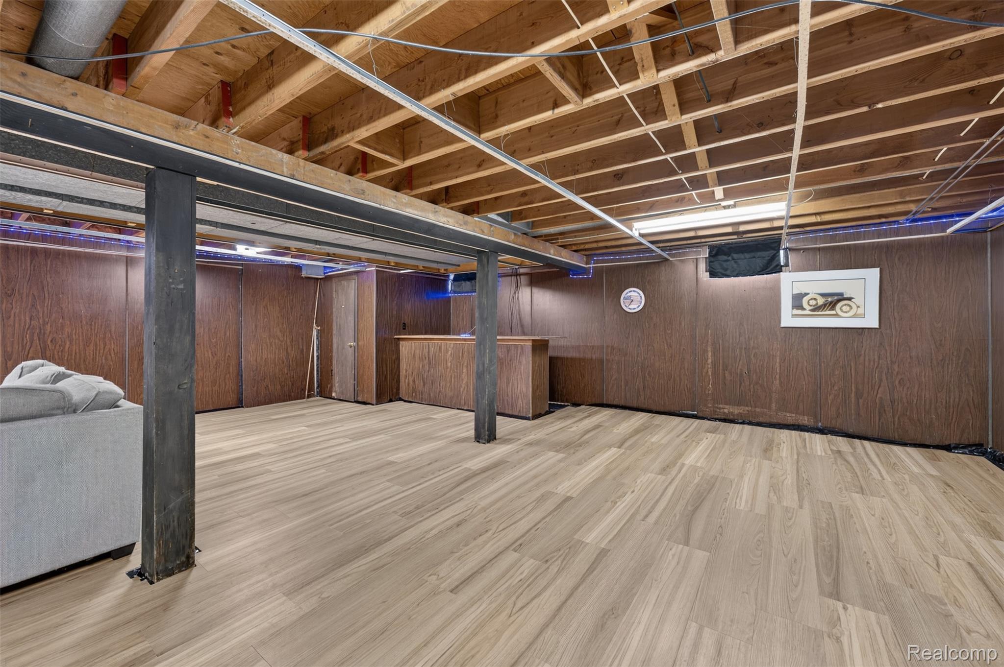 12055 West Pierson Road Flushing, MI 48433 - Photo 43 of 69 Wood-finish flooring with exposed ceiling joists and support beams