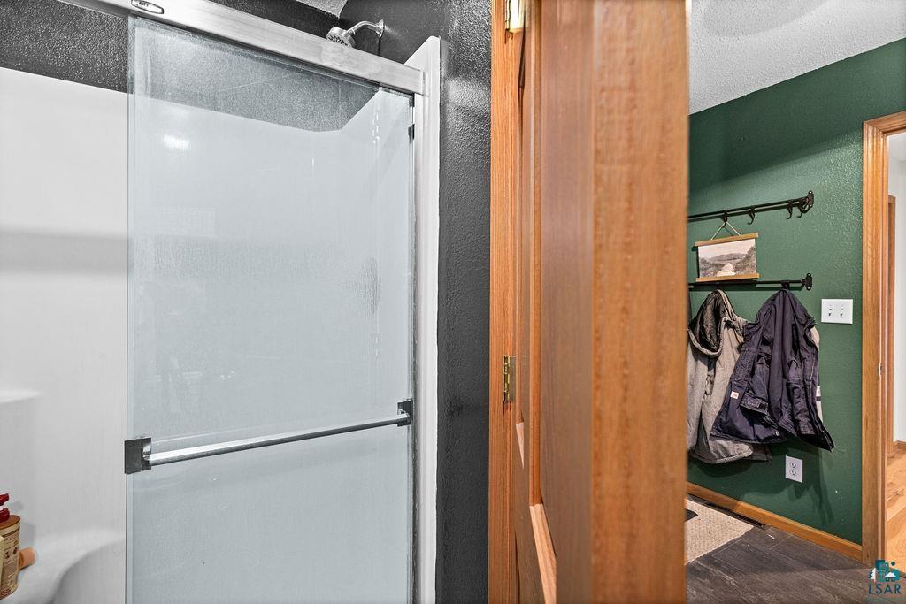 2783 Lauren Road Duluth, MN 55804 - Photo 27 of 47 Bathroom with a shower stall and a textured wall
