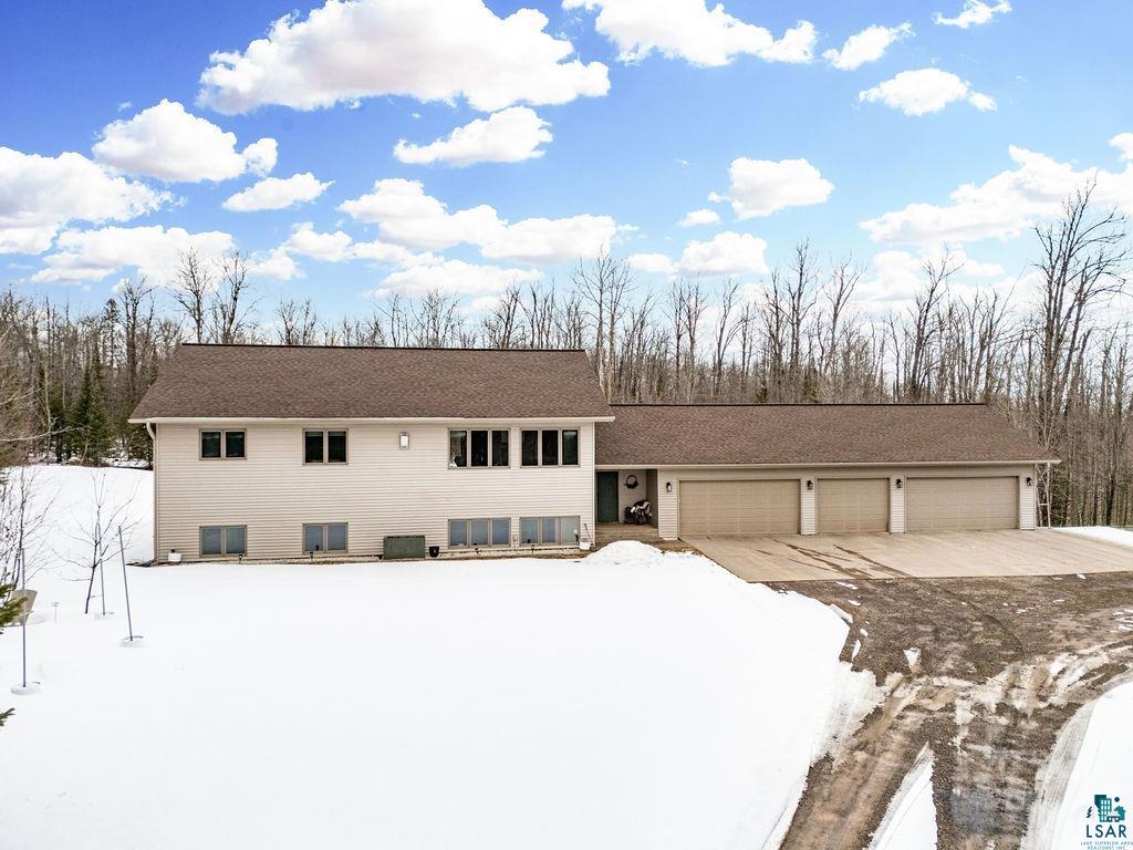 2783 Lauren Road Duluth, MN 55804 - Photo 37 of 47 View of front of house featuring roof with shingles, an attached garage, and concrete driveway