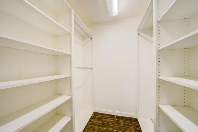 a bathroom with a double vanity sink toilet mirror and shower
