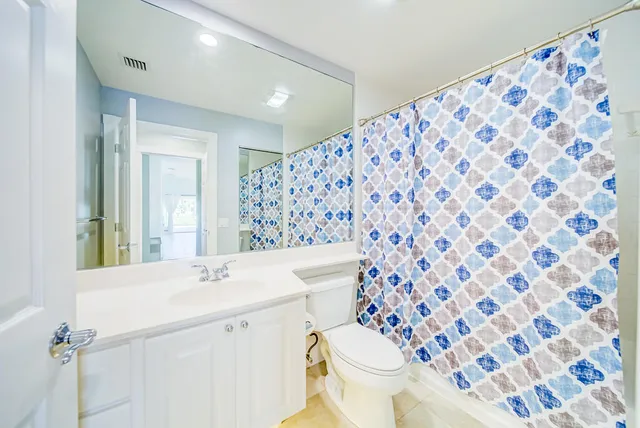 a view of room with wooden floor and fan