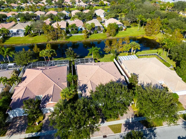 an aerial view of residential houses with outdoor space and trees