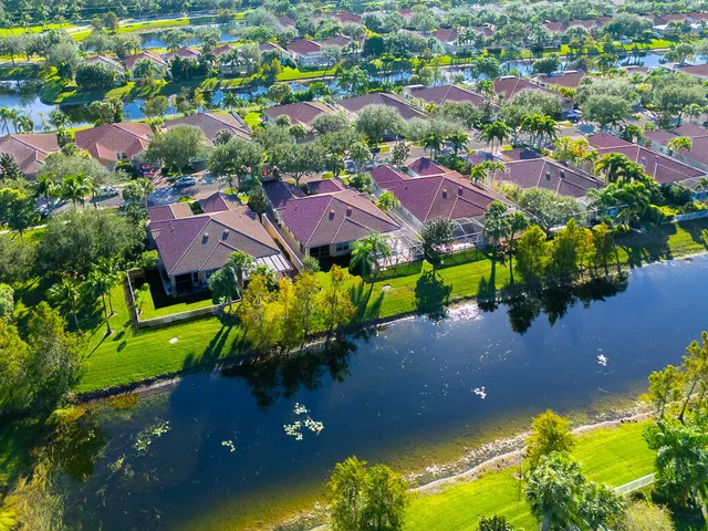 an aerial view of multiple houses with yard