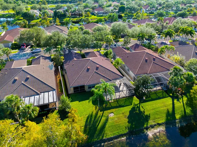 an aerial view of residential houses with outdoor space and swimming pool