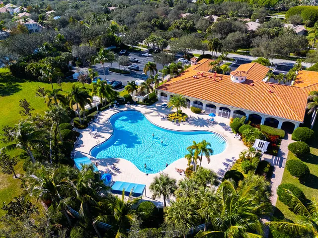 an aerial view of residential houses with outdoor space and swimming pool