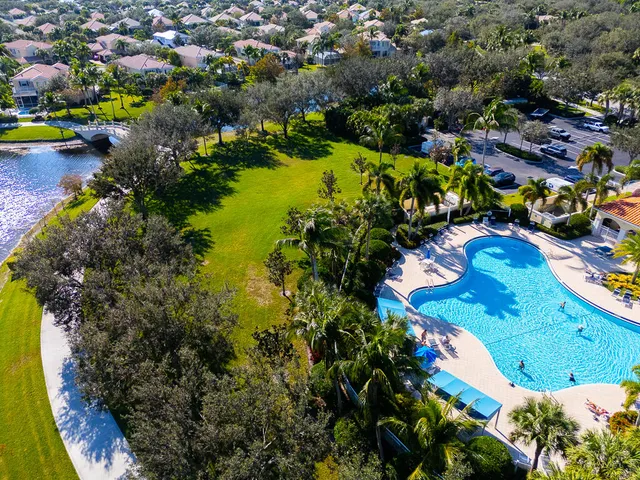 an aerial view of a residential houses with yard and swimming pool