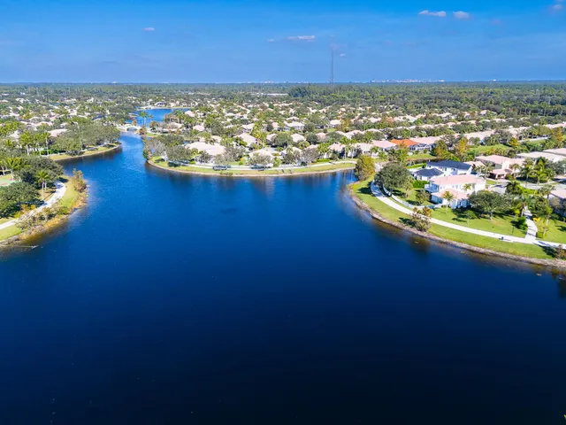 an aerial view of residential houses with outdoor space and swimming pool